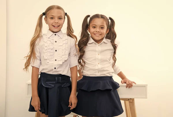 Example to follow. Schoolgirls with cute pony tails hairstyle. Best friends excellent pupils. Perfect schoolgirls with tidy fancy hair. School hairstyles ultimate top list. School fashion and style