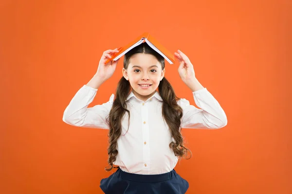 El uniforme de niño sostiene el libro. Emocionado por el conocimiento. Balance de vida y positividad. Todo está bajo control. Lidiar con el estrés escolar. Una niña sostiene el libro. Escuela chica estudiando libro de texto — Foto de Stock