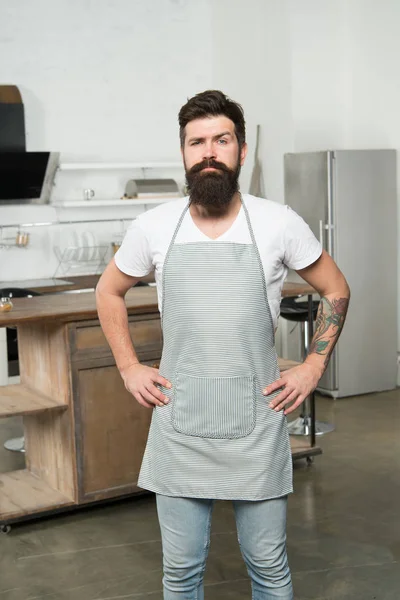 Cuisine for real men. Cooking tasty food at home. Home food. Recommend nice recipe. Culinary business. Brutal confident chef in restaurant. Hipster bearded masculine chef cooking food in kitchen