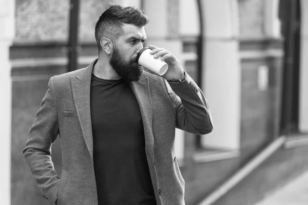 Relax and recharge. Man bearded hipster drinking coffee paper cup. One more sip of coffee. Drinking coffee on the go. Businessman lumbersexual appearance enjoy coffee break out of business center — Stock Photo, Image