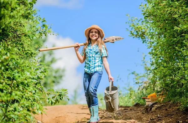 Summer farming. farmer little girl. garden, shovel and watering can. kid worker sunny outdoor. family bonding. spring country side village. future success. little girl on rancho. My job is my passion — Stock Photo, Image