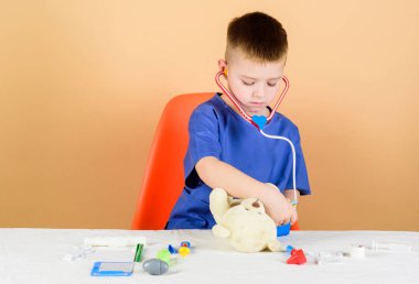 Oyuncak ayı için tıbbi prosedürler. Tıp eğitimi. Çocuk sevimli çocuk gelecek doktor kariyer. Sağlık. Çocuk küçük doktor meşgul tıbbi araçlar ile masa. Tıbbi muayene. Tıp kavramı