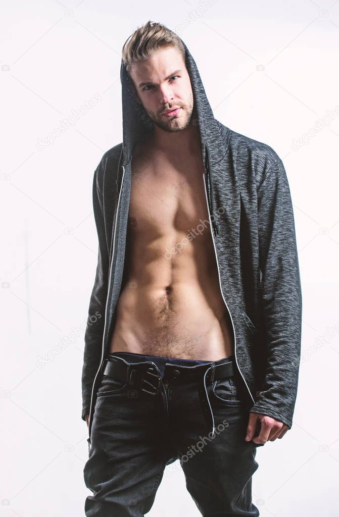 Man handsome sexy undressing. Hipster sexy muscular torso take off clothes. Seductive macho feeling sexy. Unleashed desire. Attractive sexy body. Confident in his attractiveness. Time change clothes