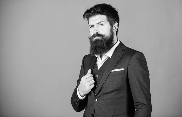 Businessman fashionable outfit stand violet background. Man bearded hipster wear classic suit outfit. Formal outfit. Elegancy and male style. Fashion concept. Guy wear formal outfit. Impeccable style