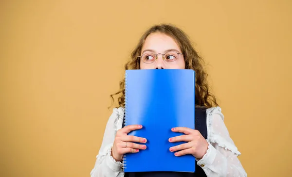 Small girl with paper folder. notebook for diary notes. study lesson. knowledge and education. Back to school. hometwork. serious small girl wants to be teacher. Doing research. copy space — Stock Photo, Image