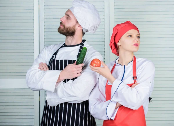 Vegetarian family. Woman and bearded man cooking together. Chefs of organic food restaurant. Cooking healthy food. Fresh vegetarian healthy food recipe. Join healthy lifestyle. Fresh vegetables