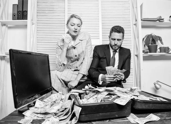 Financial success. Counting money profit. Man businessman and woman secretary with pile dollar banknotes. Profit and richness concept. Businessman near cash dollars profit. Huge profit concept