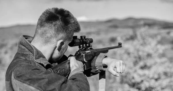 Brutal masculine hobby. Man aiming target nature background. Aiming skills. Hunter hold rifle aiming. On my target. Bearded hunter spend leisure hunting. Hunting optics equipment for professionals — Stock Photo, Image