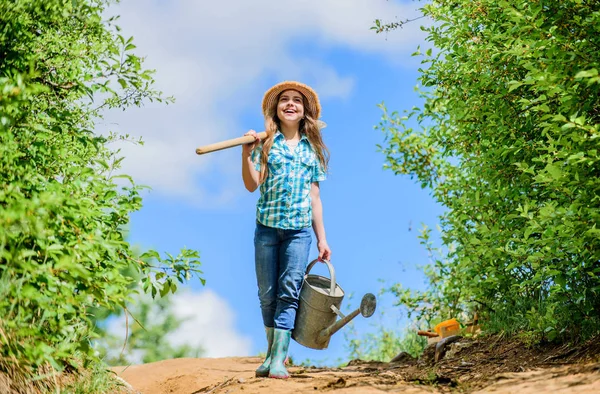 Farmer little girl. garden tools, shovel and watering can. kid worker sunny outdoor. family bonding. spring country side village. future success. little girl on rancho. summer farming — Stock Photo, Image