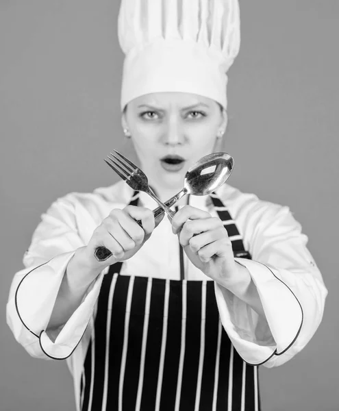 Appetite and taste. Traditional culinary. Professional cook of culinary school. Culinary arts academy. Culinary school concept. Woman professional chef hold utensil spoon and fork. Time to eat