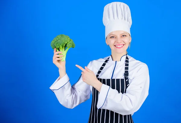 Woman chef hold broccoli vegetable. Healthy vegetarian recipes. Healthy food. Dieting concept. Eat healthy. Girl hold vegetable. Organic nutrition. Broccoli has impressive nutritional profile