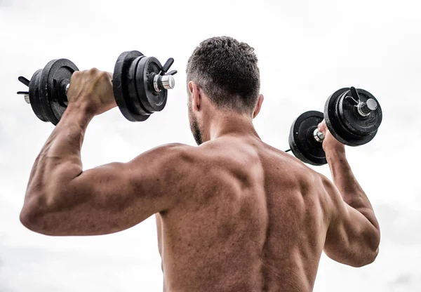 Healthy lifestyle. athletic body. Dumbbell gym. fitness and sport equipment. man sportsman weightlifting. steroids. Muscular back man exercising in morning with barbell. Working his core muscles — Stock Photo, Image