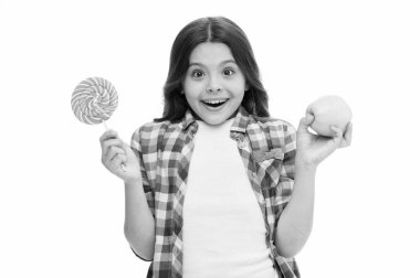 Doğru seçimi yap. Şeker tatlısı bizi mutlu edebilir mi? Kız tatlı lolipop ve elma tutuyor. Okul yemeği alternatif konsepti. Kız şeker ya da meyve seçiyor. Aynı tatlı elma ve şeker tadı