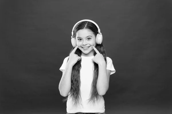 A música desempenha um papel importante vidas adolescentes. Música de efeito potente adolescentes as suas emoções, percepção do mundo. Menina ouvir fones de ouvido música no fundo vermelho. Concepção de lista de reprodução. Sabor musical — Fotografia de Stock