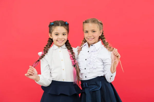 Best friends excellent pupils. Schoolgirls tidy appearance glad to meet you. Meet new friends in school. School friendship. Should school be more fun. Schoolgirls with cute hairstyle and happy smiles — Stock Photo, Image