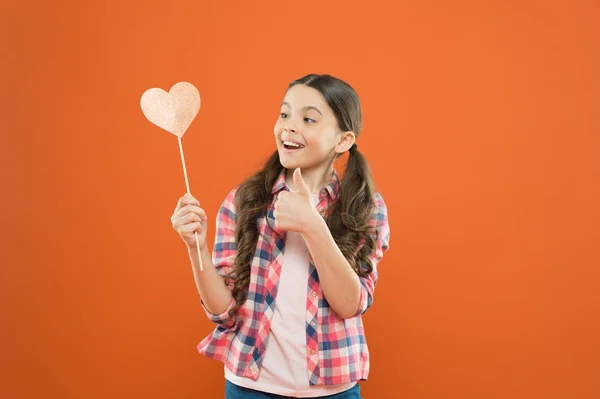 I definitely like this. Vote for love. Girl little child hold heart symbol on stick. Like and support. Valentines day. Fall in love. Love will save the world. Kid promoting love. Personal attitude — Stock Photo, Image