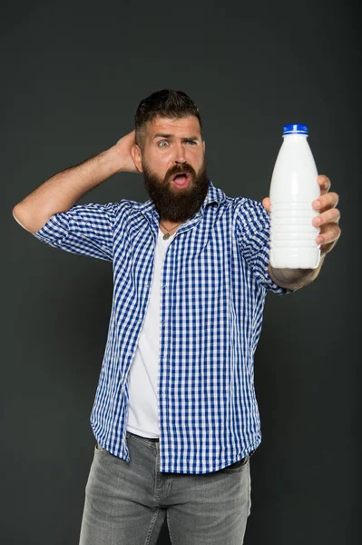 Consuming lactose. Healthy nutrition. Yogurt probiotics and prebiotics. Bearded man hold white bottle with milk. Brutal caucasian hipster drink milk. Lactose diet. Health care and diet. Milk products