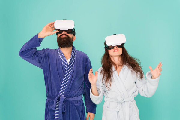 Looking upwards. Gaming and entertainment. Future closer than you think. Family explore VR at home. VR technology and future. VR communication. Exciting impressions. Couple bathrobes wear VR glasses