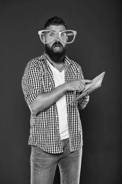Literary club. Reading book as hobby. Study is fun. Hipster bearded man funny eyeglasses hold notepad or book. Read this book. Comic and humor sense. Courses adult education. Self education concept — Stock Photo, Image