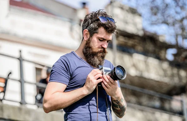 nice shot. retro photographic equipment. hipster man in summer sunglasses. photo of nature. reporter or journalist. Mature hipster with beard. Bearded man. brutal photographer with camera