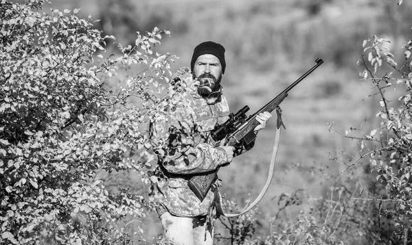 Man hunter with rifle gun. Boot camp. Military uniform fashion. Bearded man hunter. Army forces. Camouflage. Hunting skills and weapon equipment. How turn hunting into hobby. Victim of violence