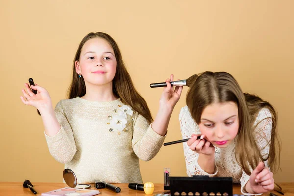 Children little girls make up face. Makeup store. Experimenting with style. Creativity is best makeup skill. Make up school. Makeup art. Explore moms cosmetics bag concept. Salon and beauty treatment