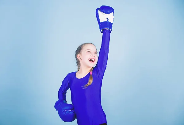 Always in good shape. Sport success. sportswear fashion. workout of small girl boxer. punching knockout. Childhood activity. Fitness diet. energy health. Happy child sportsman in boxing gloves
