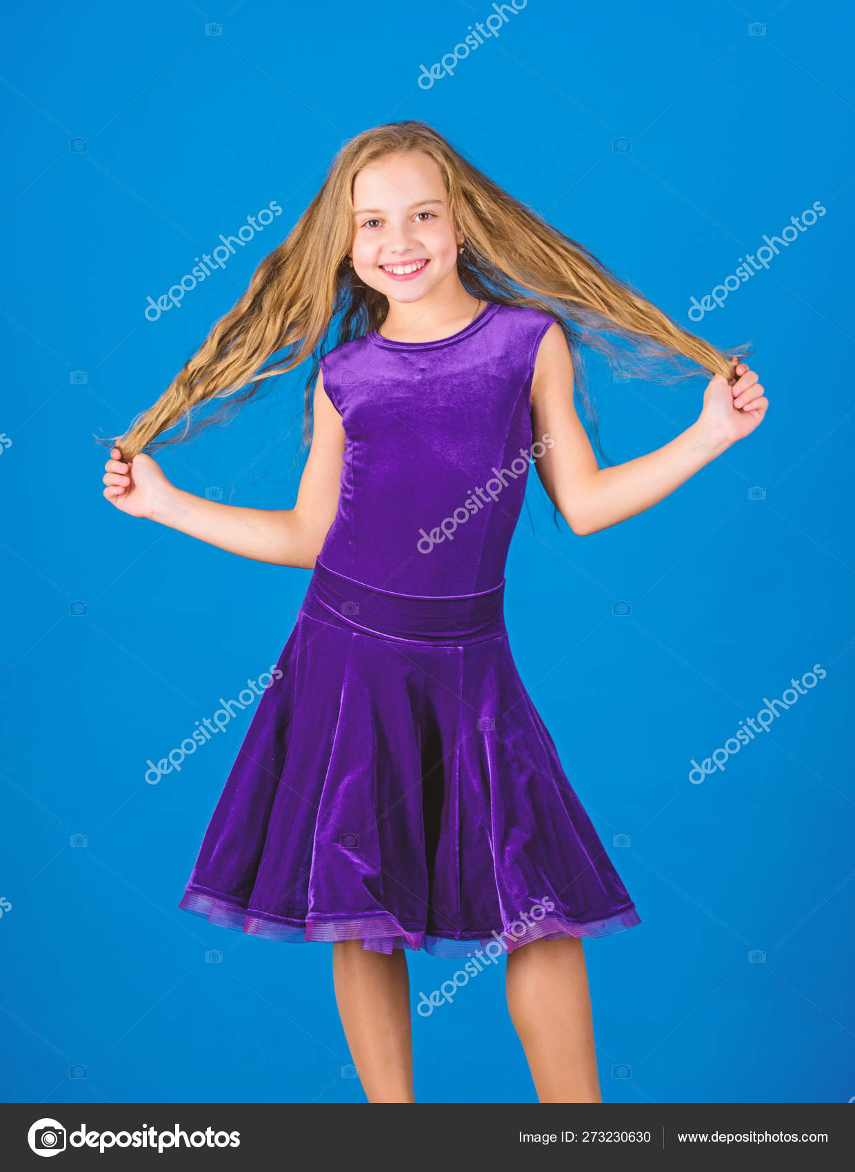 Kid Girl With Long Hair Wear Dress On Blue Background