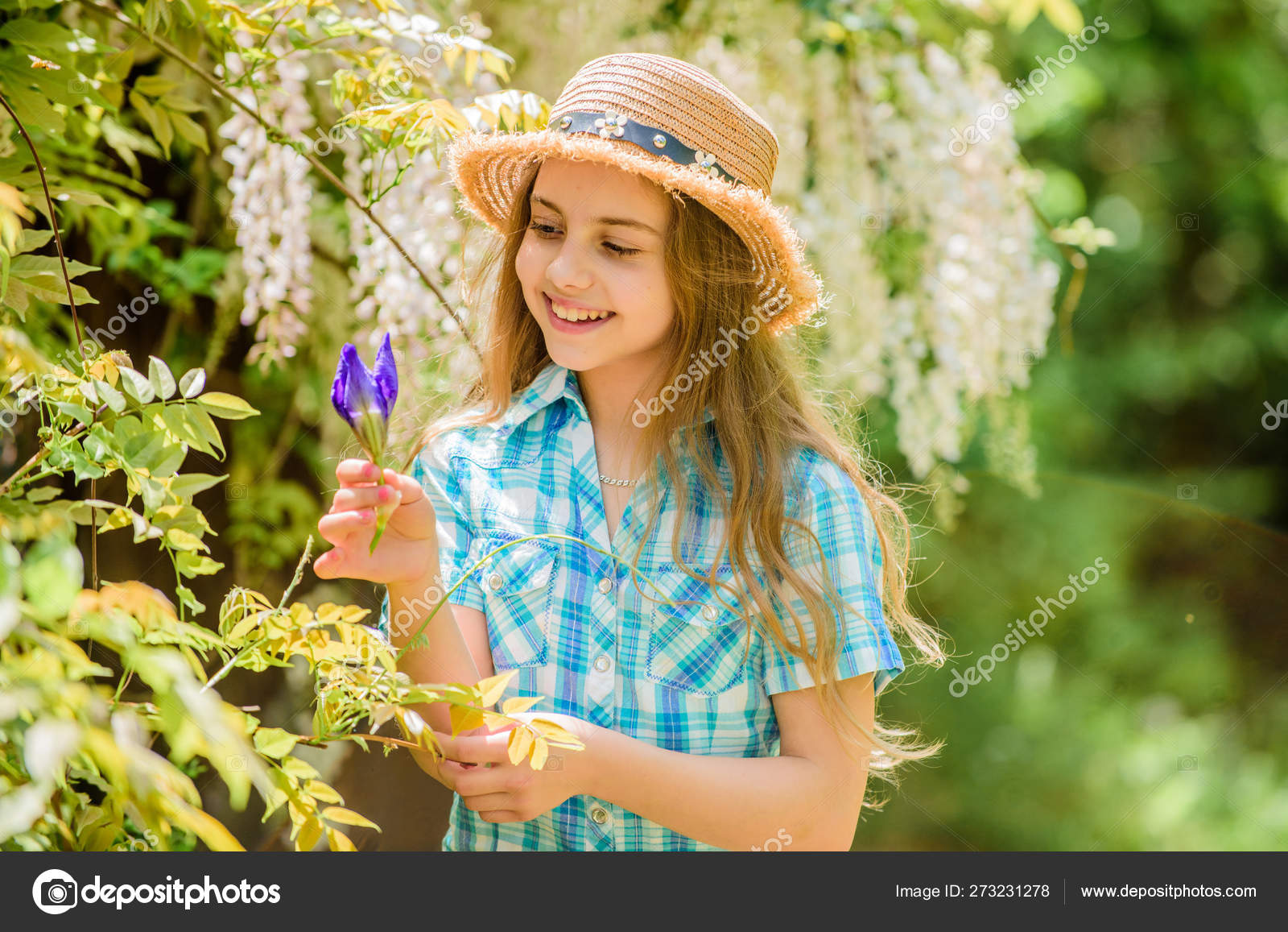 Florist. Spring holiday. Womens day. Natural beauty. Childhood happiness. happy child hold iris flower. summer vacation. Green environment. little girl and iris flower. Living in the moment