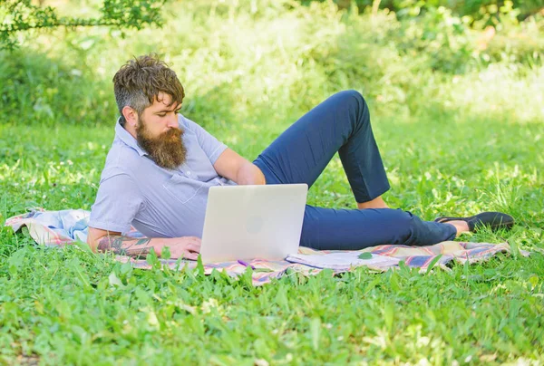 Man bearded with laptop relaxing meadow nature background. Writer looking for inspiration nature environment. Inspiration for blogging. Blogger becoming inspired by nature. Looking for inspiration