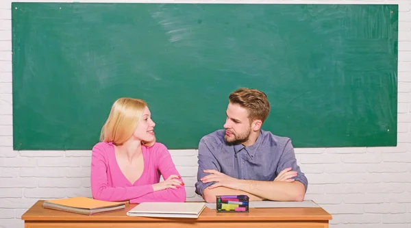 Correct answer on their mind. Studying in college or university. Apply for free program. Couple friends students studying university. Enjoying university life. Guy and girl sit at desk in classroom
