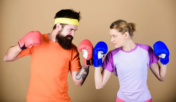 Boxing sport concept. Couple girl and hipster practicing boxing. Sport for everyone. Amateur boxing club. Equal possibilities. Strength and power. Man and woman in boxing gloves. Family battle