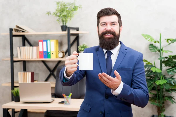 Boss enjoying energy drink. Caffeine addicted. Start day with coffee. Man bearded businessman hold coffee cup stand office background. Successful people drink coffee. Drinking coffee relaxing break
