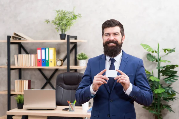 Bank card. Financial support. Bearded hipster top manager hold card. Banking services. Guy formal suit stand in office. Businessman hold blank card. Finance and accounting. Easy and quick payment