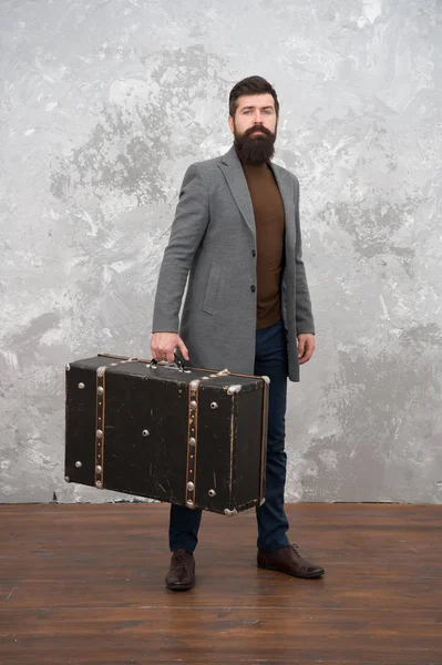 Retro and vintage. Fashion trend. Accessories for vacation. Best travel bags for men. Guy well groomed elegant bearded man and vintage suitcase. Time traveller concept. Vintage inspired design of bag