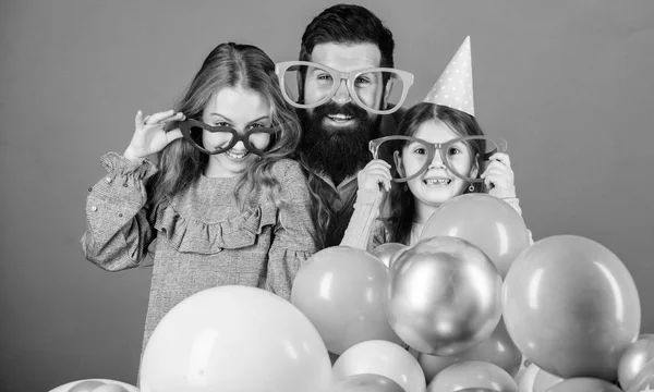 Happy birthday. Having a family celebration. Happy family celebrating birthday party. Family party. Family of father and daughters wearing party goggles. Father and girl children enjoying party time