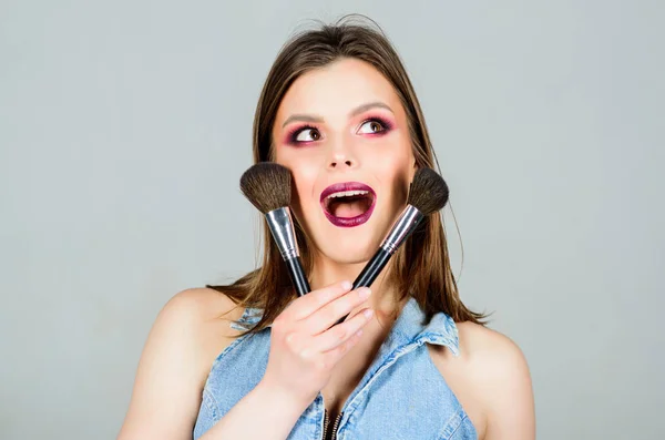 Woman applying makeup brush. Emphasize femininity. Different brushes. Professional makeup supplies. Skin care. Makeup cosmetics concept. Skin tone concealer. Cosmetics shop. Girl apply eye shadows — Stock Photo, Image