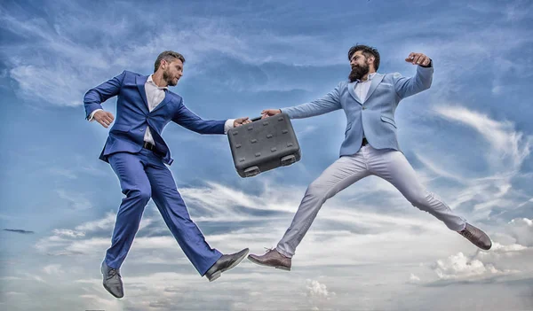Easy deal business. Businessmen jump fly mid air while hold briefcase. Case with raise your business. Successful transaction between businessmen. Briefcase handover in heaven blue sky background