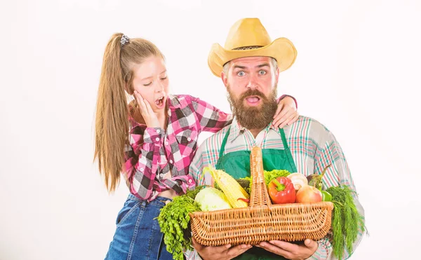 Father farmer or gardener with daughter hold basket harvest vegetables. Man bearded rustic farmer with kid. Family farm organic vegetables. Farmers family homegrown harvest. Gardening and harvesting