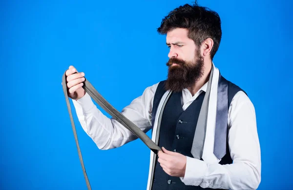 By presenting polished look for work or social occasions, neckties enhance wardrobe. Man bearded hipster hold few neckties. Guy with beard choosing tie. Perfect necktie. Types of necktie accessories