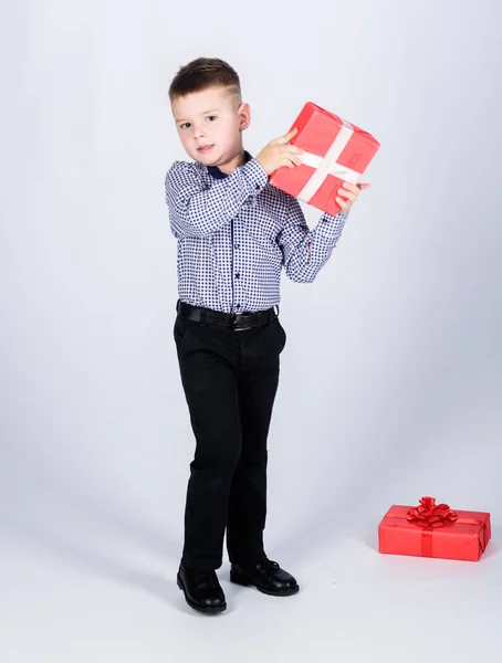 Buy gifts. Holiday shopping seasonal sale. Wellbeing and positive emotions. Celebrate new year valentines day. Birthday gift. Small boy hold gift box. Christmas or birthday gift. Dreams come true