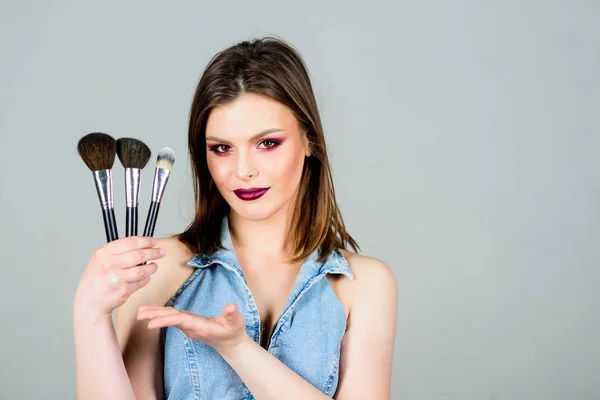 Makeup cosmetics concept. Emphasize femininity. Girl apply eye shadows. Looking good and feeling confident. Woman applying makeup brush. Professional makeup supplies. Different brushes. Skin care — Stock Photo, Image