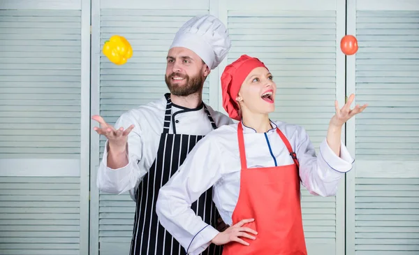 happy couple in love with healthy food. Family cooking in kitchen. man and woman chef in restaurant. Dieting vitamin. culinary cuisine. vegetarian. cook uniform. Happy loving couple play with food