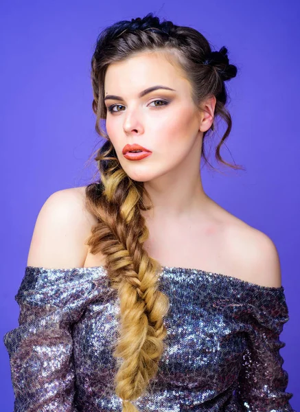 Braided hairstyle. French braid. Professional hair care and creating hairstyle. Beauty salon hairdresser art. Beautiful young woman with modern hairstyle. Girl makeup face braided long hair