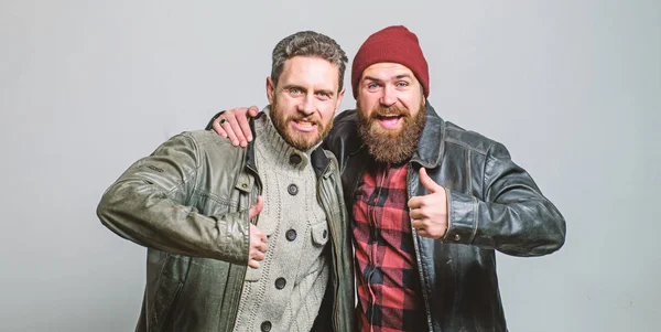 Real men and brotherhood. Friends glad see each other. Friendly relations. Friendship of brutal guys. Real friendship mature friends. Male friendship concept. Brutal bearded men wear leather jackets