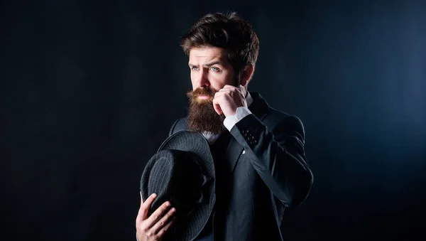 Formal suit classic style outfit. Elegant and stylish hipster. Retro fashion hat. Man with hat. Vintage fashion. Man well groomed bearded gentleman on dark background. Male fashion and menswear