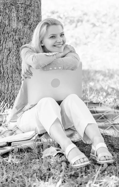 Природный офис. Женщина с ноутбуком работает на открытом воздухе постное дерево. Минута отдыха. Образовательные технологии и интернет-концепция. Преимущества работы на открытом воздухе. Девушка работает с ноутбуком в парке сидеть на траве — стоковое фото