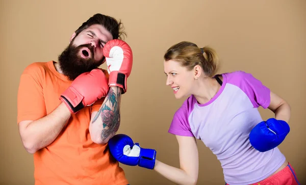 Couple girl and hipster practicing boxing. Sport for everyone. Amateur boxing club. Equal possibilities. Strength and power. Family violence. Man and woman in boxing gloves. Boxing sport concept