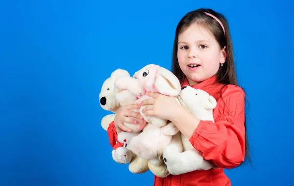 Happy childhood. Little girl play with soft toy teddy bear. Lot of toys in her hands. Collecting toys hobby. Cherishing memories of childhood. Childhood concept. Small girl smiling face with toys — Stock Photo, Image