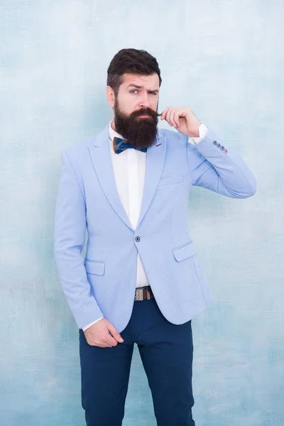 Stylist fashion expert. Suit style. Fashion trends for groom. Groom bearded hipster man wear light blue tuxedo and bow tie. Wedding day. Stylish groom. Statement with his stunning crisp suit jacket